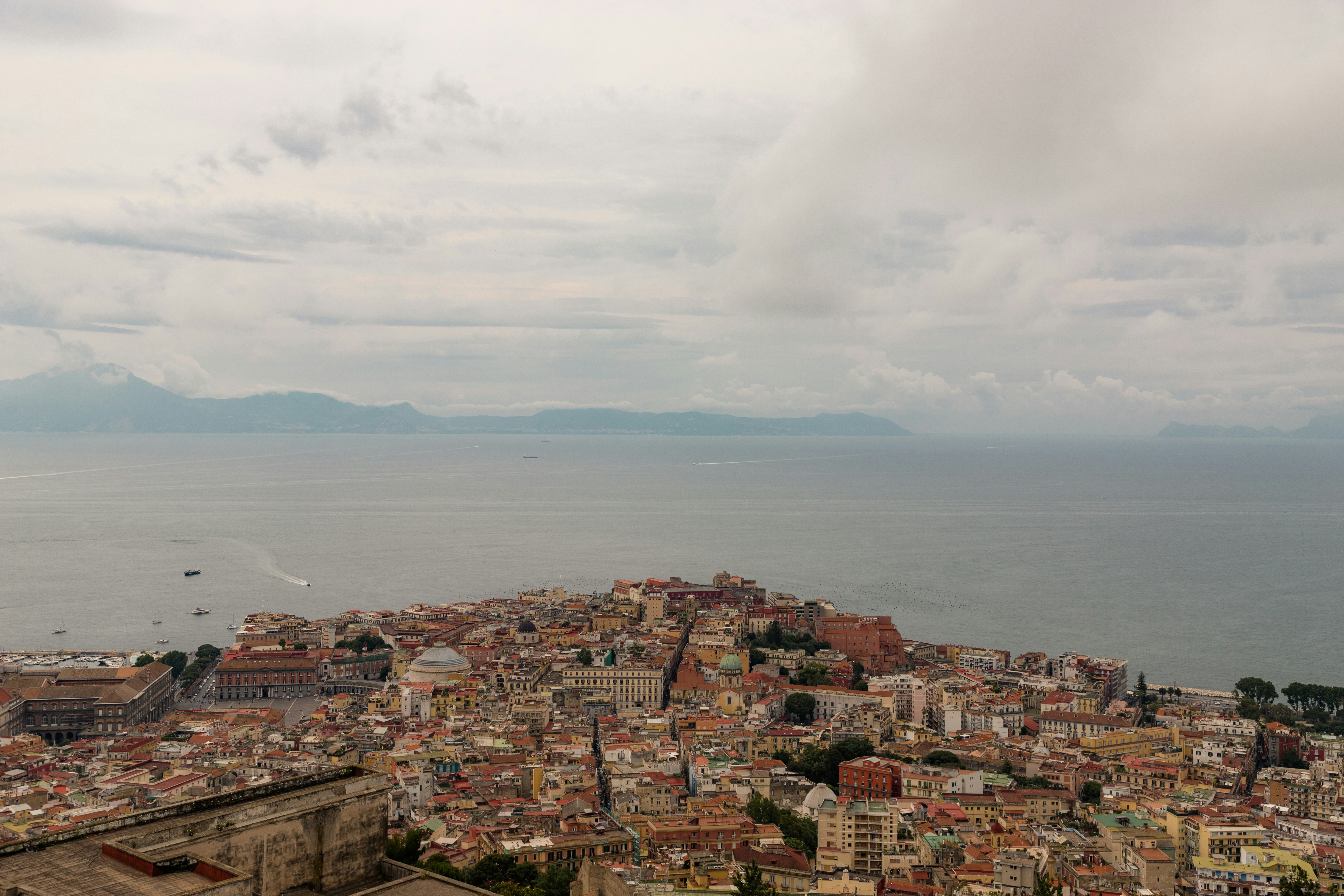 a view of a city with a body of water in the background