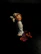 Vintage miniature sculpture displayed on a wooden pedestal against a soft background.