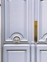 A detailed view of the door’s ornate handle and lock mechanism gleaming in the light.