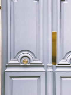 A detailed view of the door’s ornate handle and lock mechanism gleaming in the light.