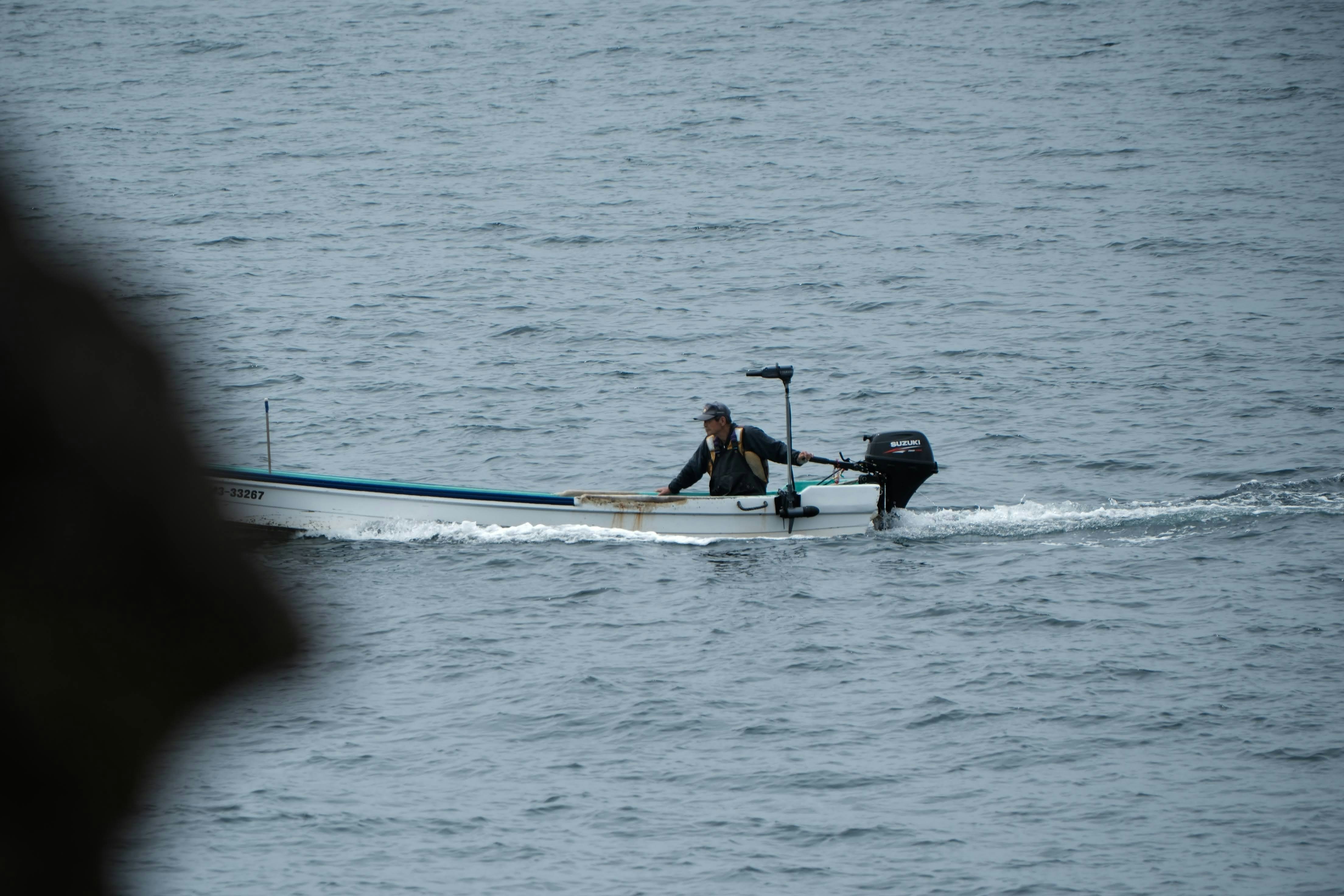 a man in a boat on a body of water