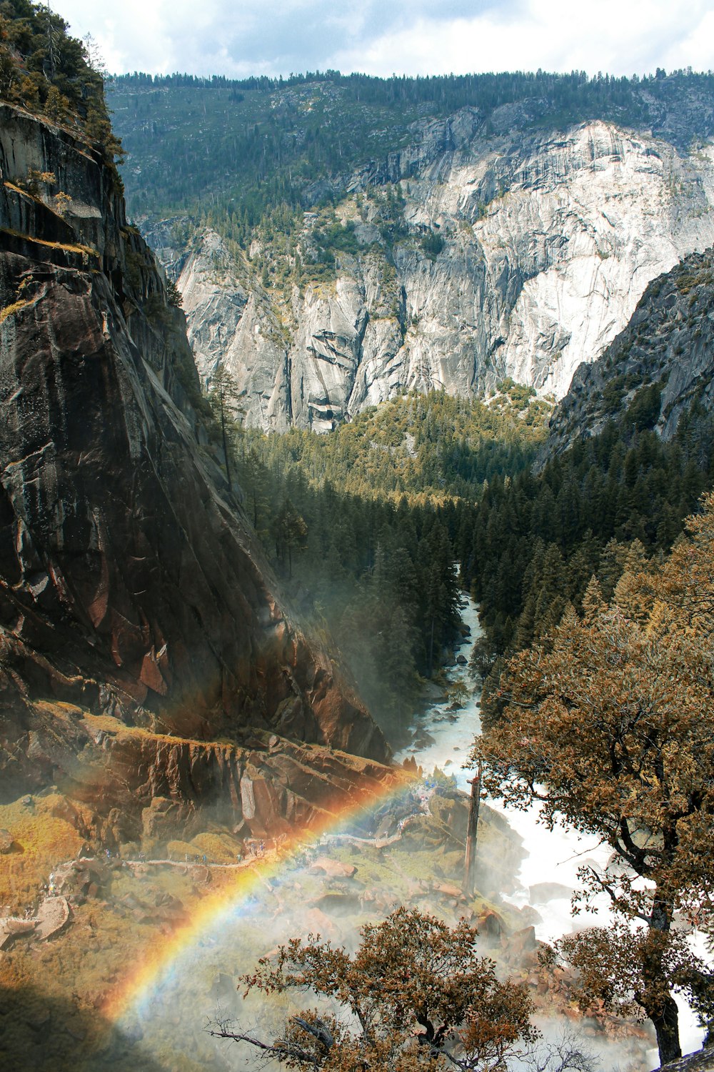 a rainbow in the middle of a valley