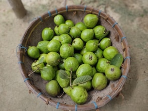 Baskets filled with green guanabana fruits displayed at a local farm.