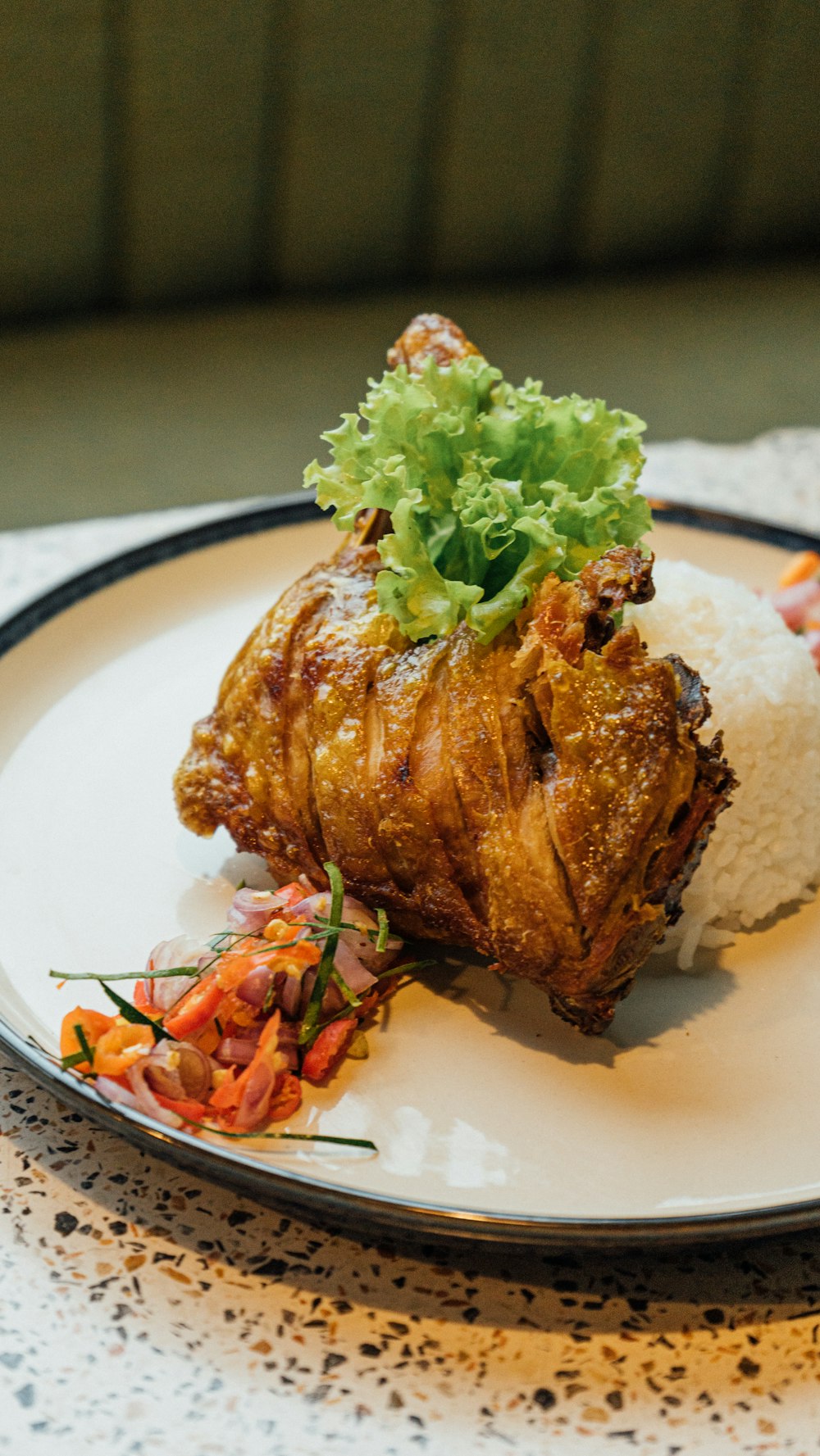 a white plate topped with meat and rice