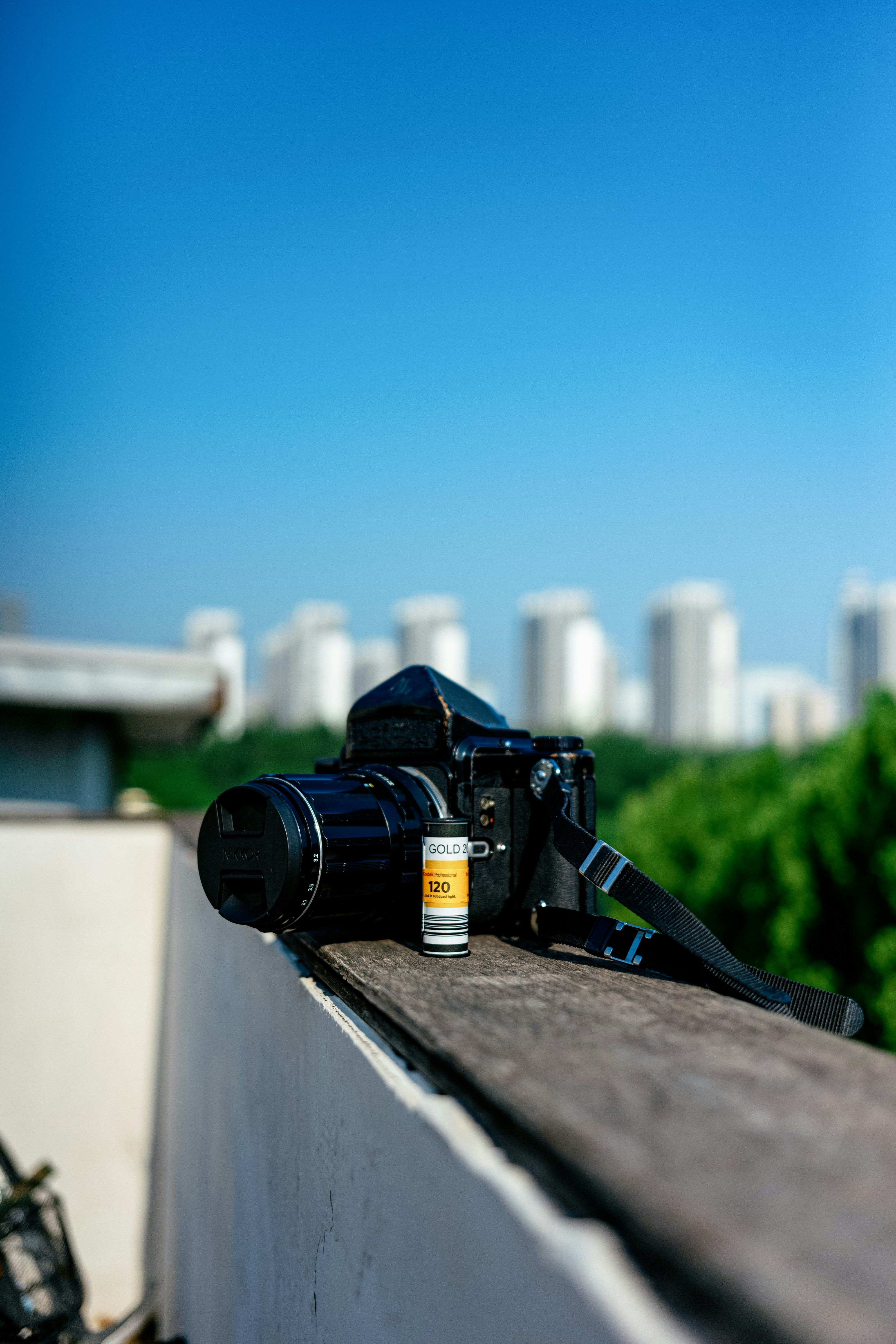 A camera sitting on top of a wooden ledge photo – Free Photography ...