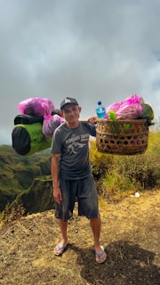 Porters carrying camping gear through rugged mountain paths