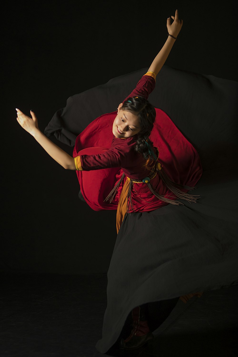 a woman in a red shirt and black skirt