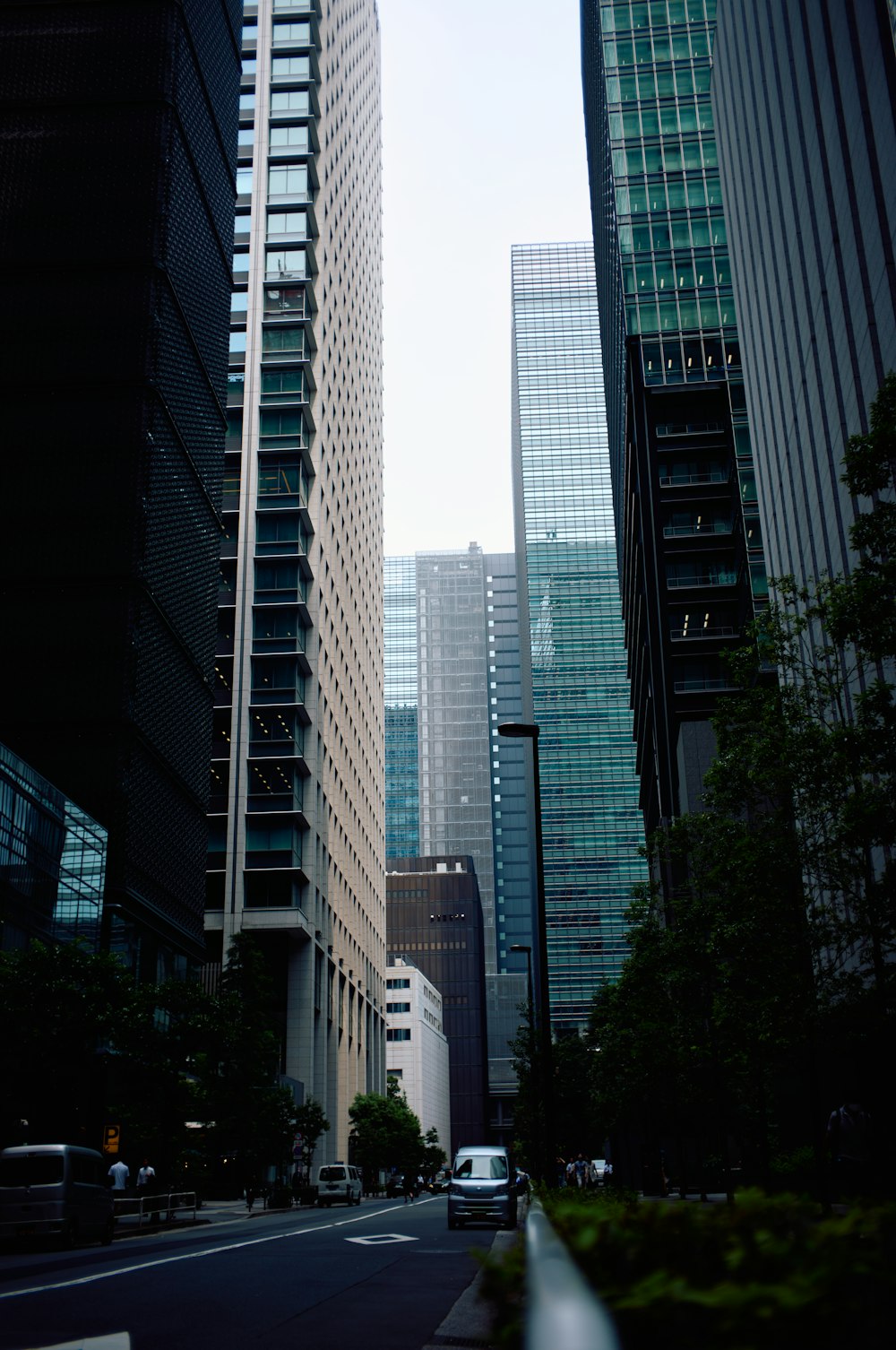 a city street with tall buildings in the background