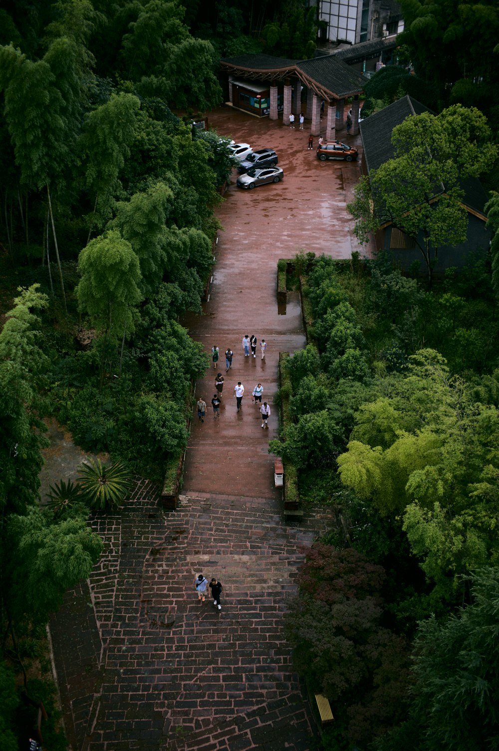 a group of people walking down a brick pathway