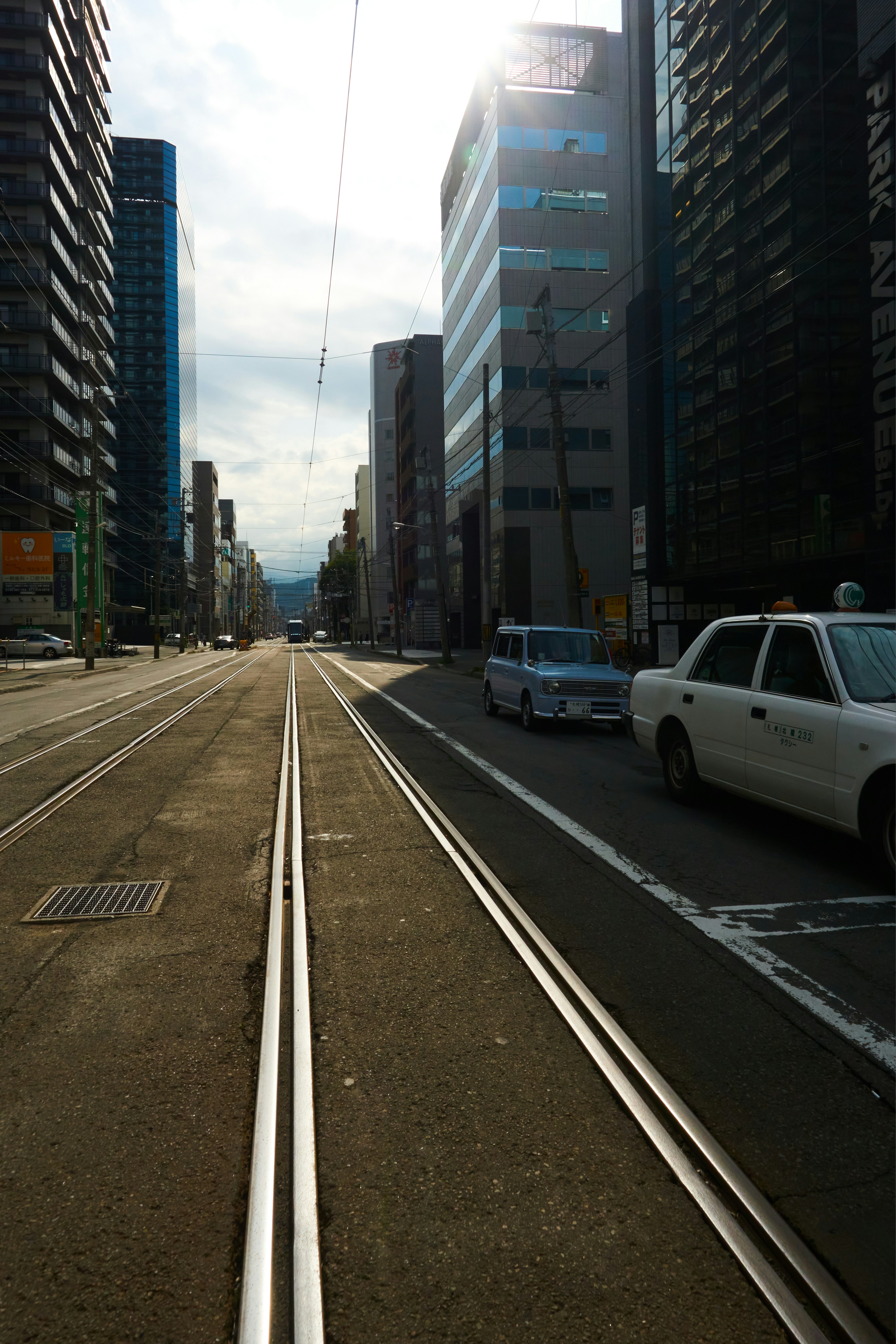 A city street filled with traffic next to tall buildings photo – Free ...