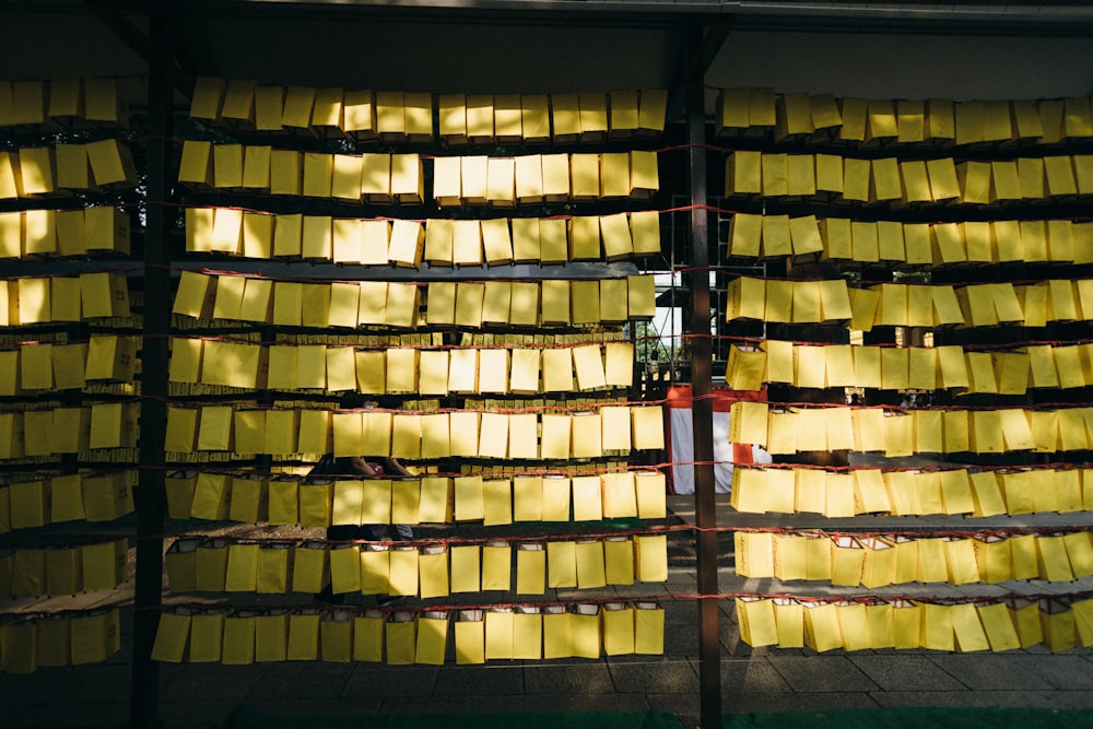 a large amount of yellow sticky notes on a rack