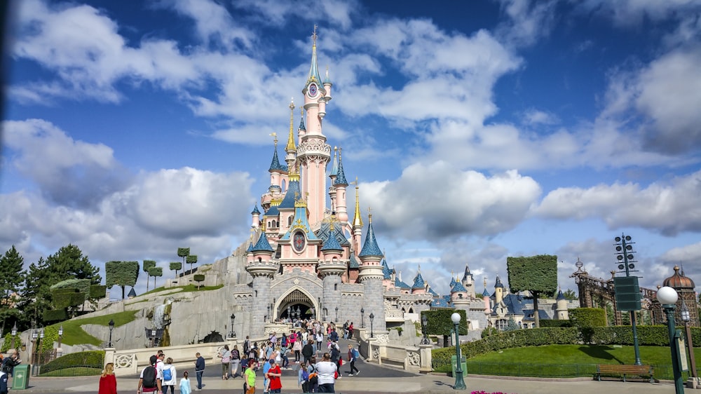 a group of people standing in front of a castle