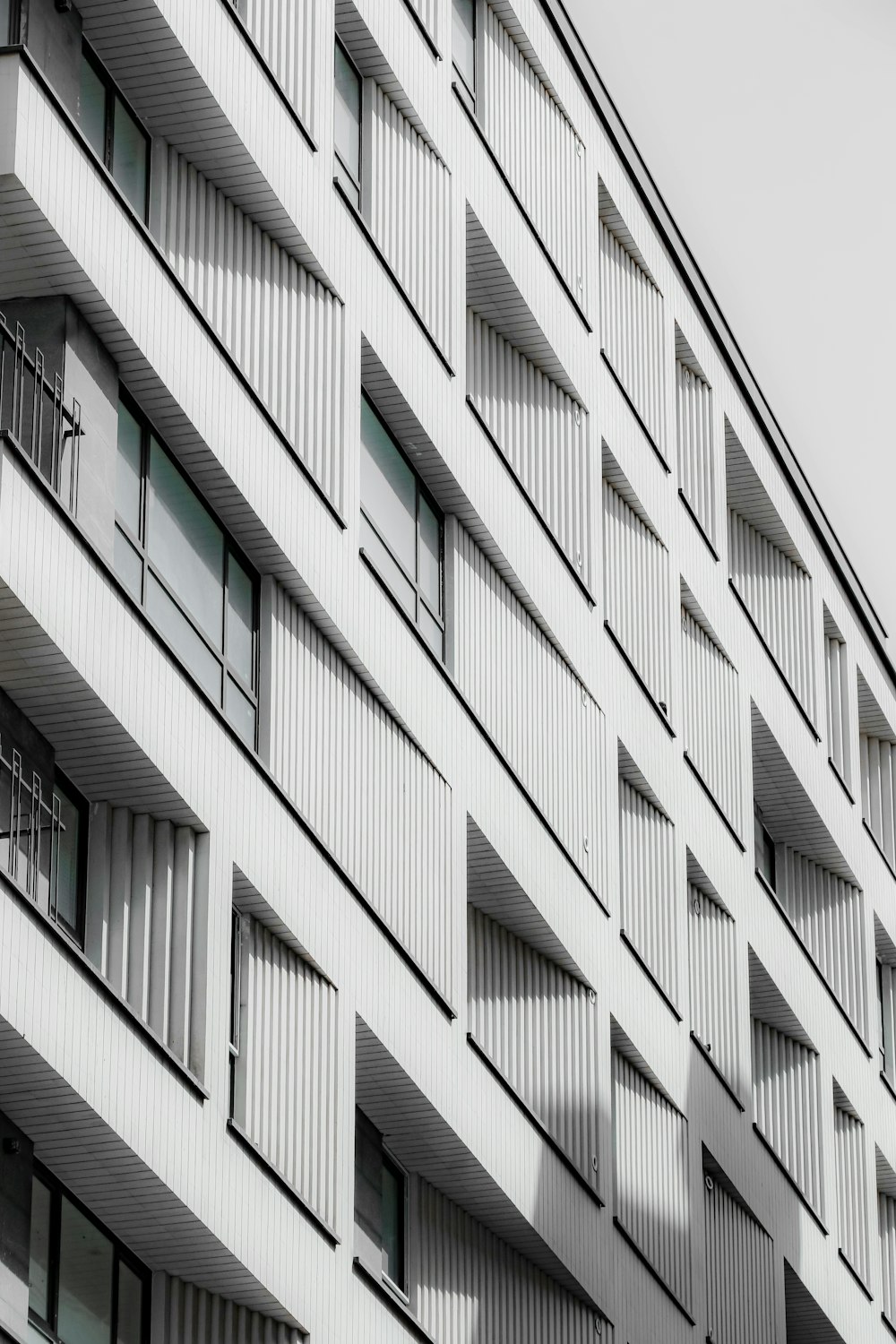 a tall white building with lots of windows