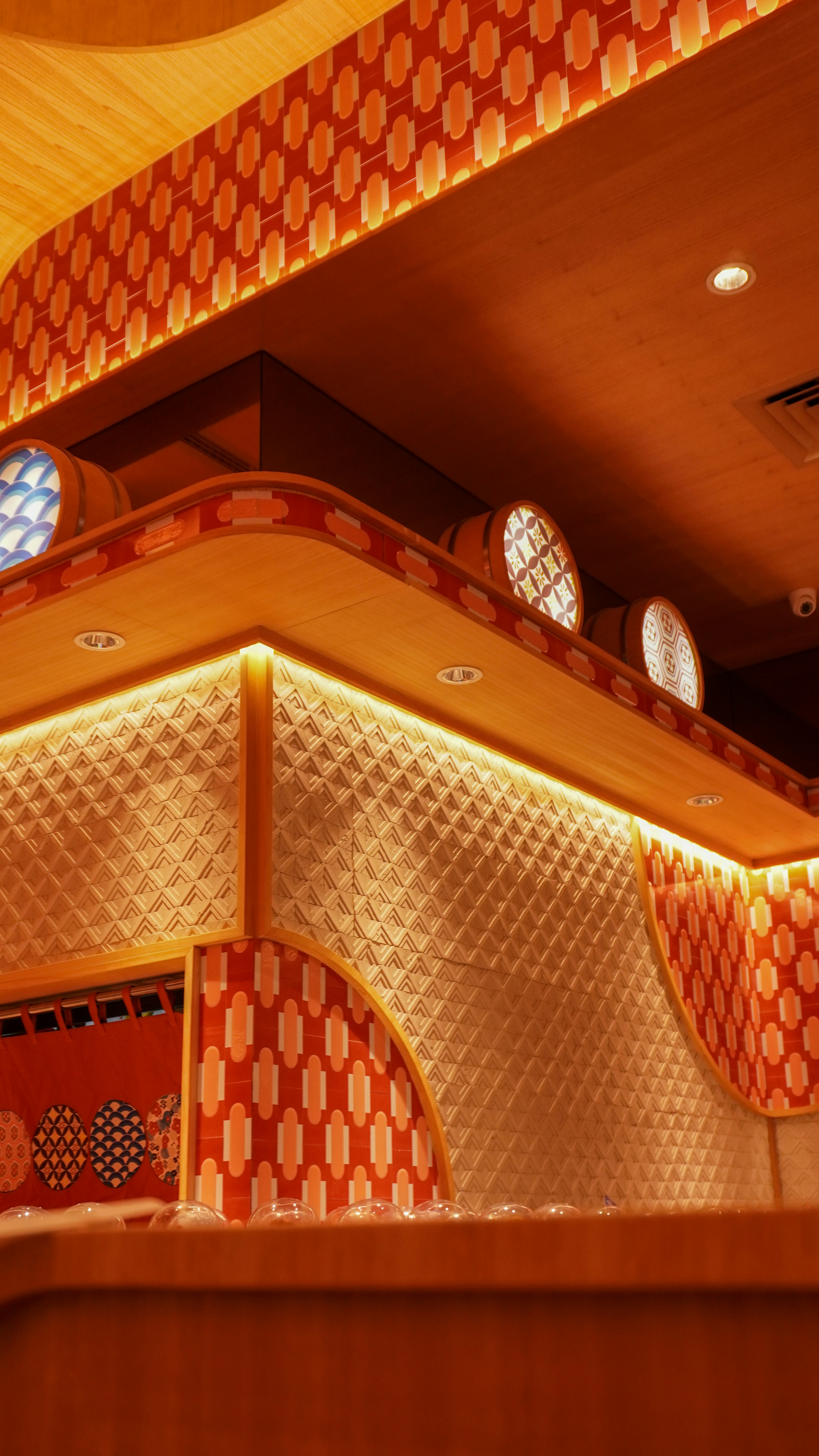 a room with a checkered wall and round windows