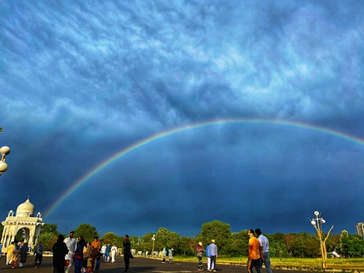 A warm, welcoming community gathering under a bright sky, symbolizing unity and hope.