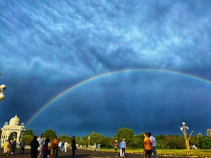 A vibrant gathering of diverse believers worshiping together under an open sky.