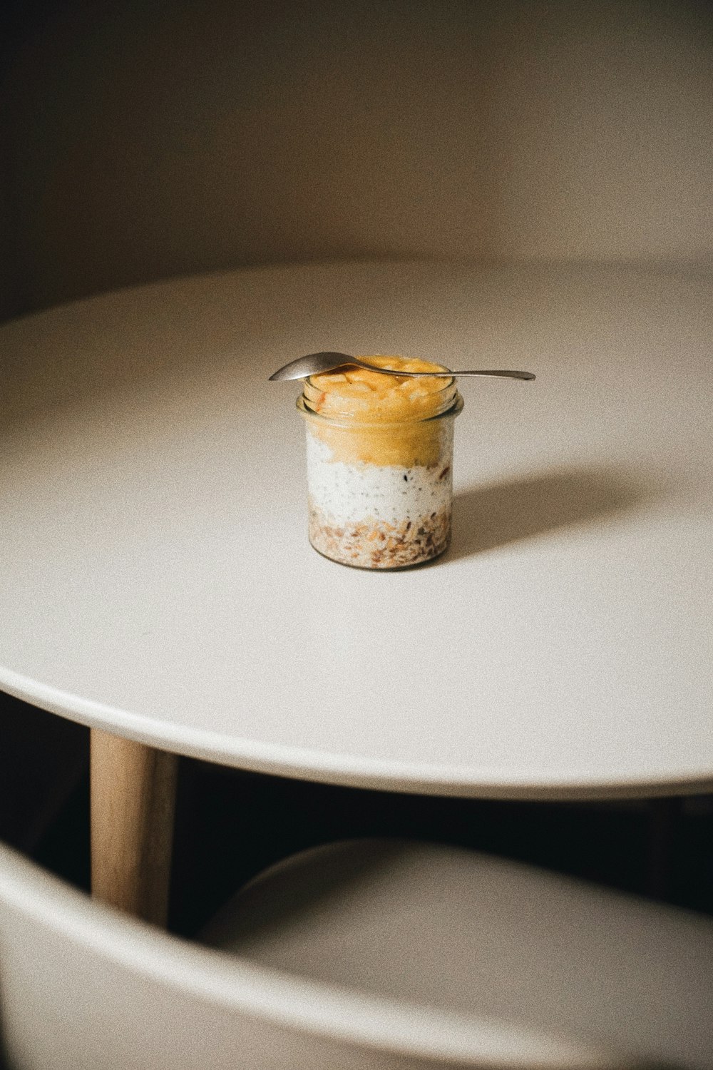 a jar of food sitting on top of a white table