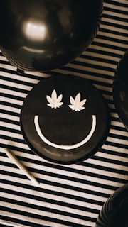 a black cake with a smiley face on it