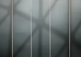 Four-column grid layout showing minimalist product images with white text and gold accents