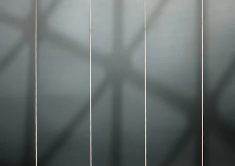 Four-column grid layout showing minimalist product images with white text and gold accents