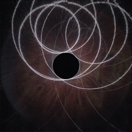 Dark navy background with gold orbital lines circling a glowing hub symbolizing dynamic operations in motion.