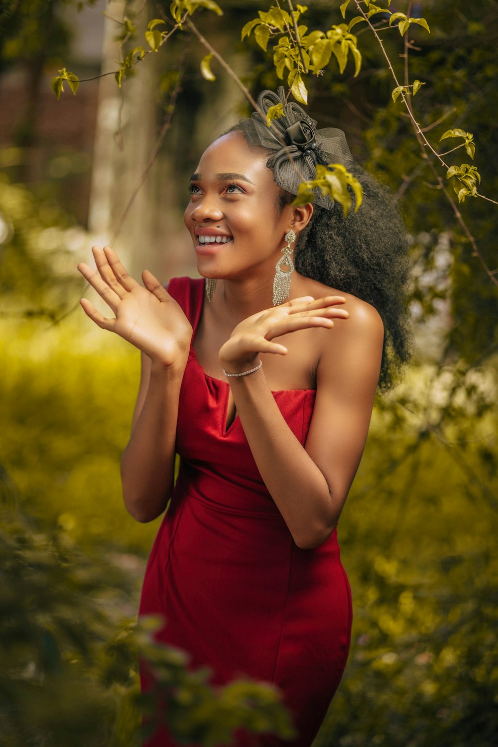 a woman in a red dress is smiling and clapping