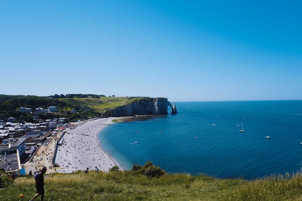 a view of a beach from a hill overlooking the ocean