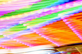 A vibrant video still showcasing a range of colorful products in motion.