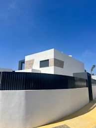 A minimalist blueprint sketch of a modern residential home with clean lines and geometric shapes.