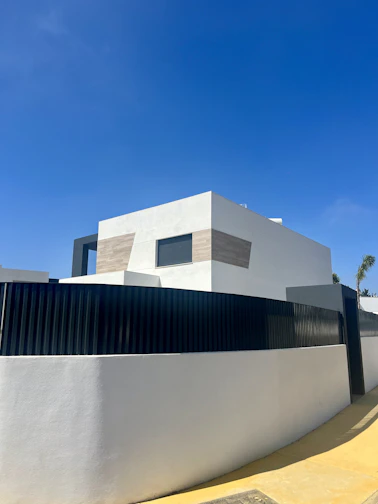 A modern prefab house exterior with clean lines and large windows.