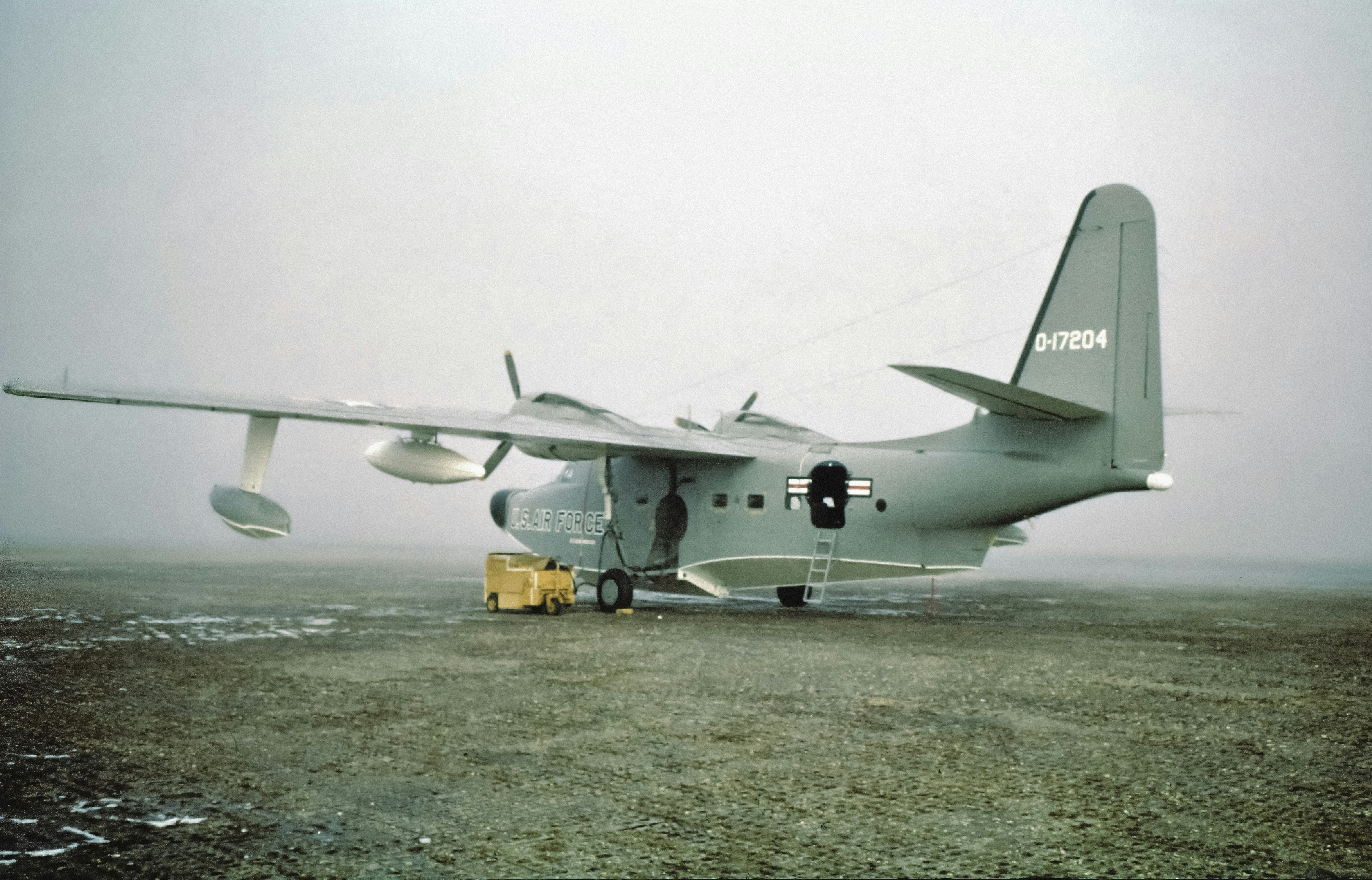 A large airplane sitting on top of a dirt field photo – Free Plane ...