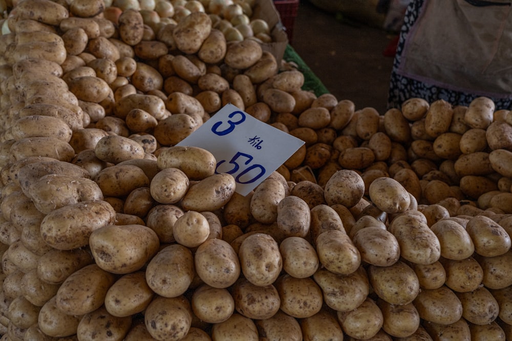 a pile of potatoes for sale at a market