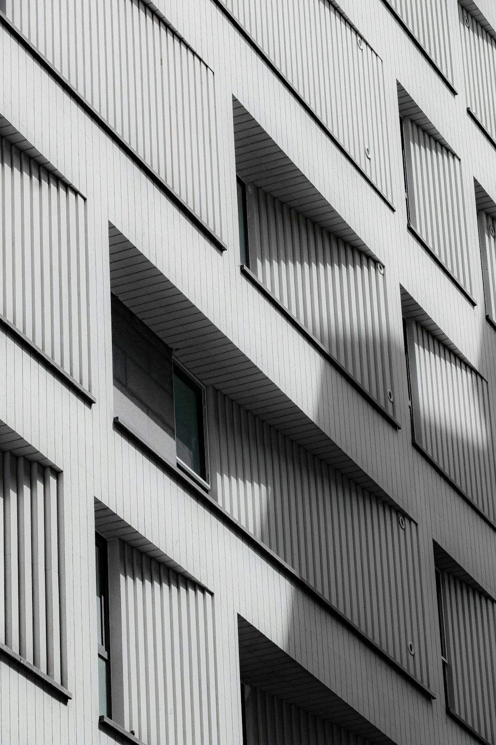 a tall building with lots of windows and shutters