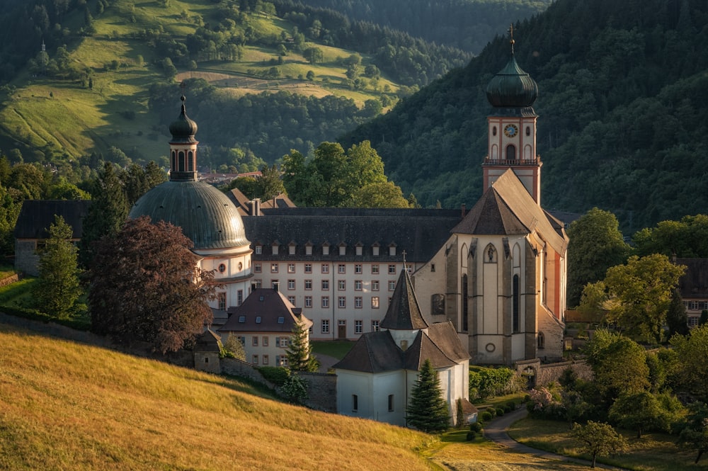 a large building with a steeple on top of a hill