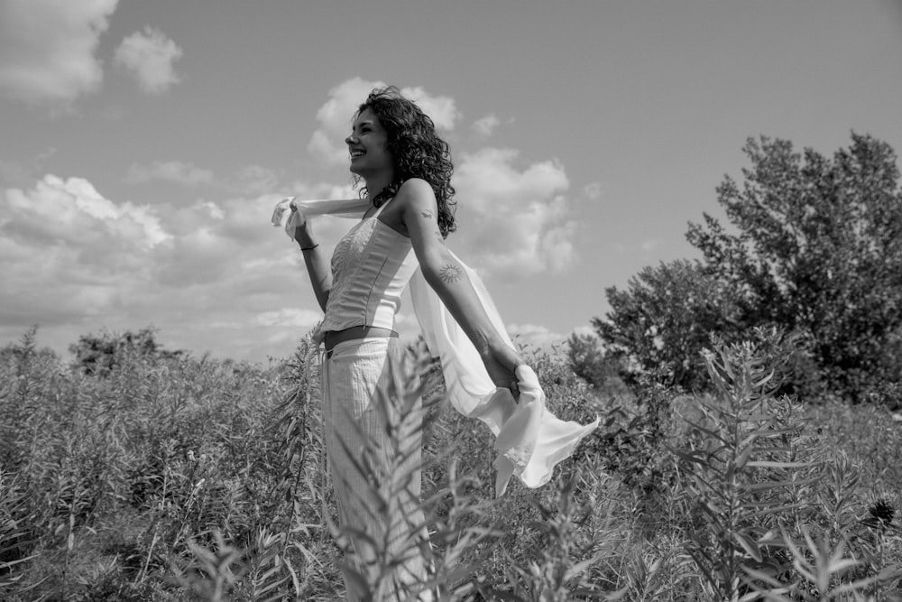 a woman standing in a field of tall grass