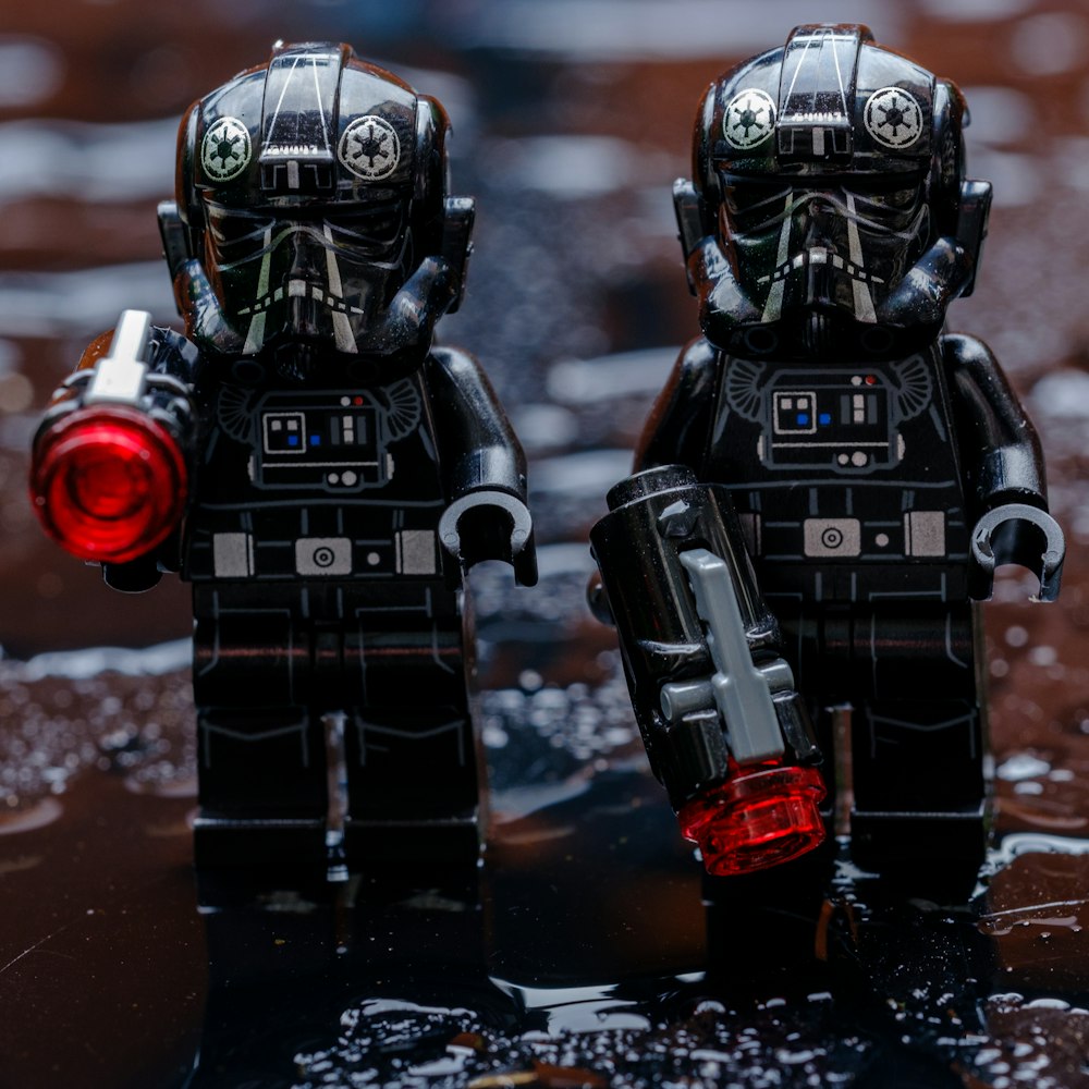 a couple of legos that are standing in the water