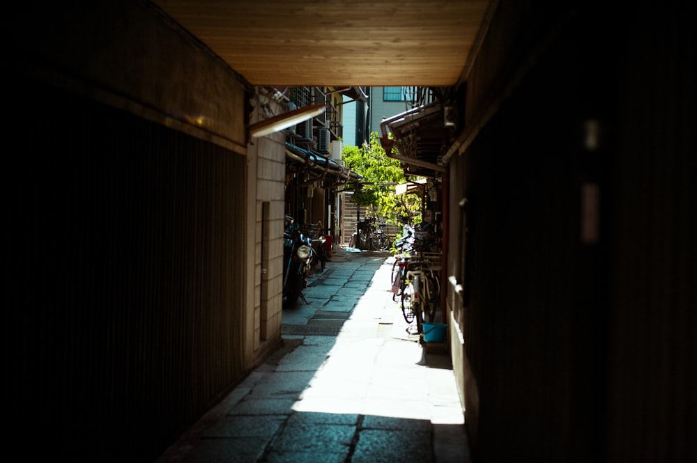a narrow alley way with bicycles parked on the side of it