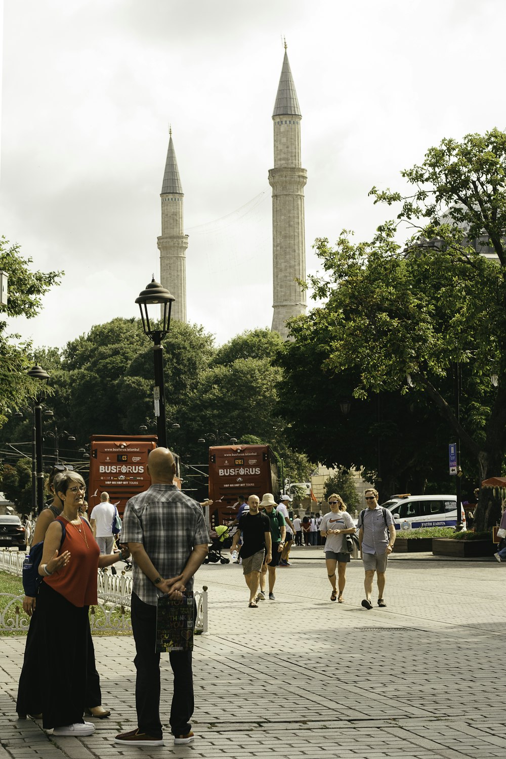 a group of people standing on a sidewalk