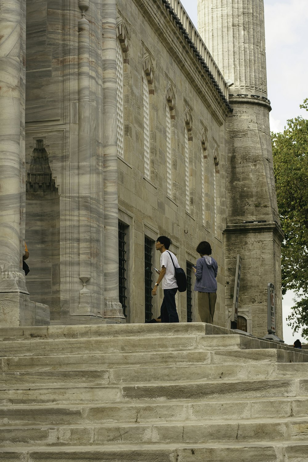 a couple of people that are standing on some steps