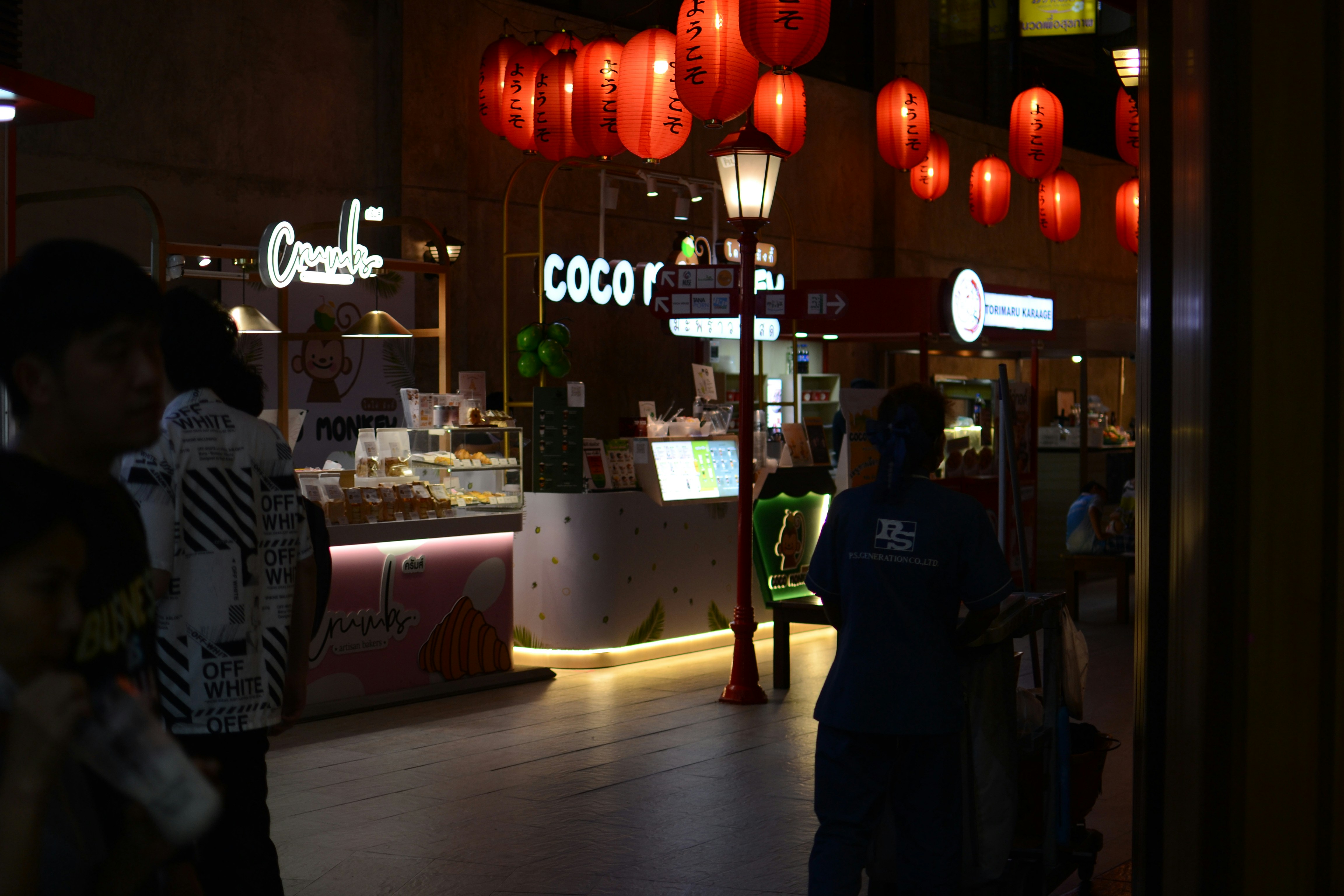 Chinese street food market at dusk with warm lantern glow, atmospheric evening scene with neon signs