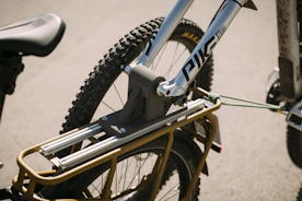 A sturdy bicycle carrier attached to the back of a vehicle with bikes loaded