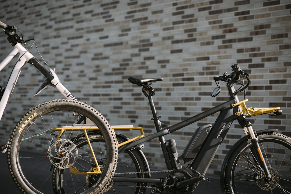 a bicycle parked in front of a brick wall