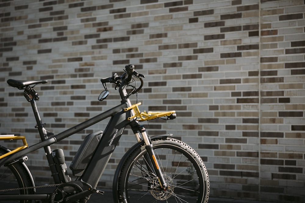 a bicycle parked in front of a brick wall