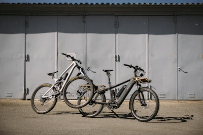 A lineup of electric bikes and dirt bikes ready for their next adventure, gleaming under shop lights.