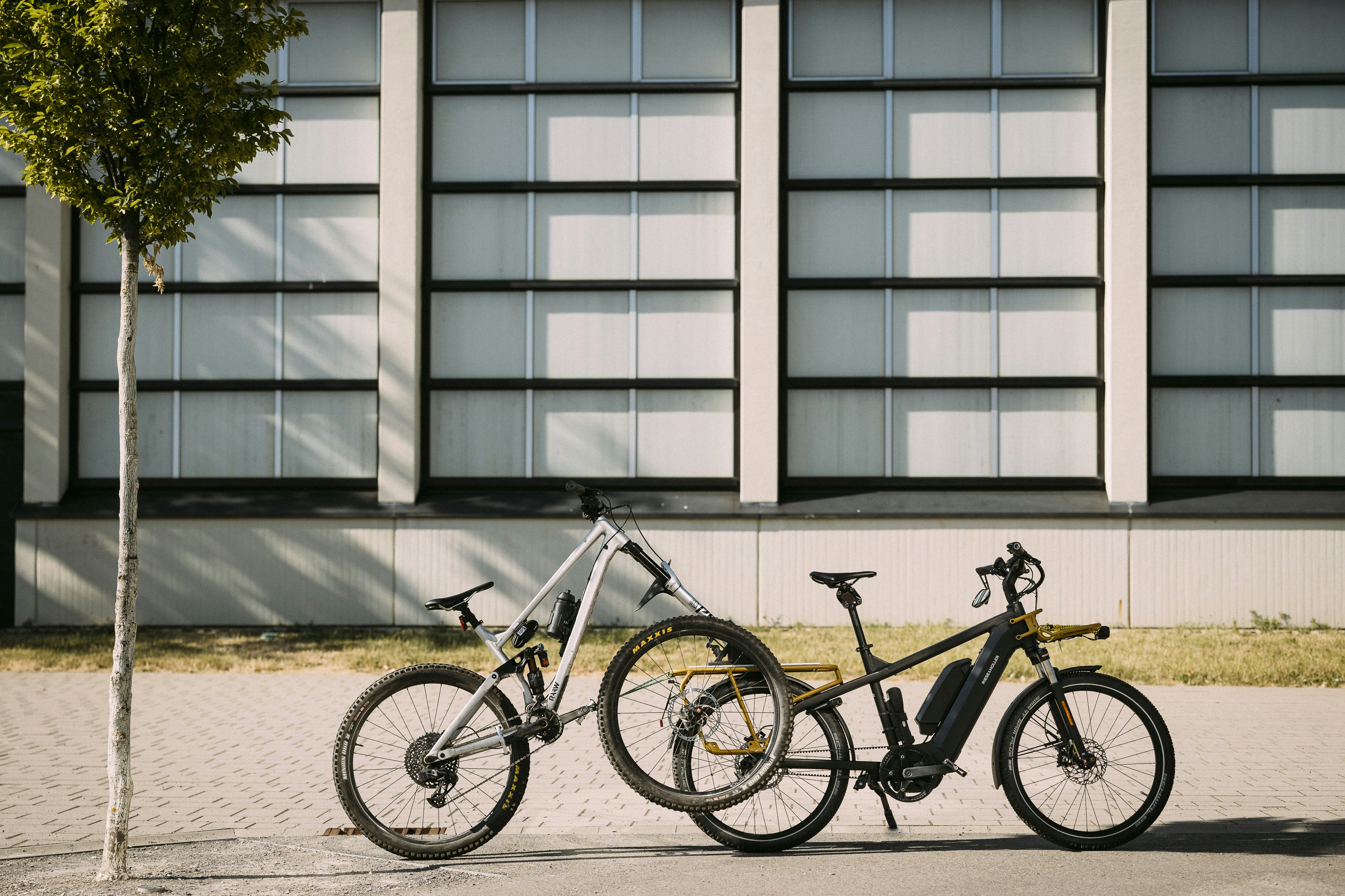 two bikes parked next to each other in front of a building