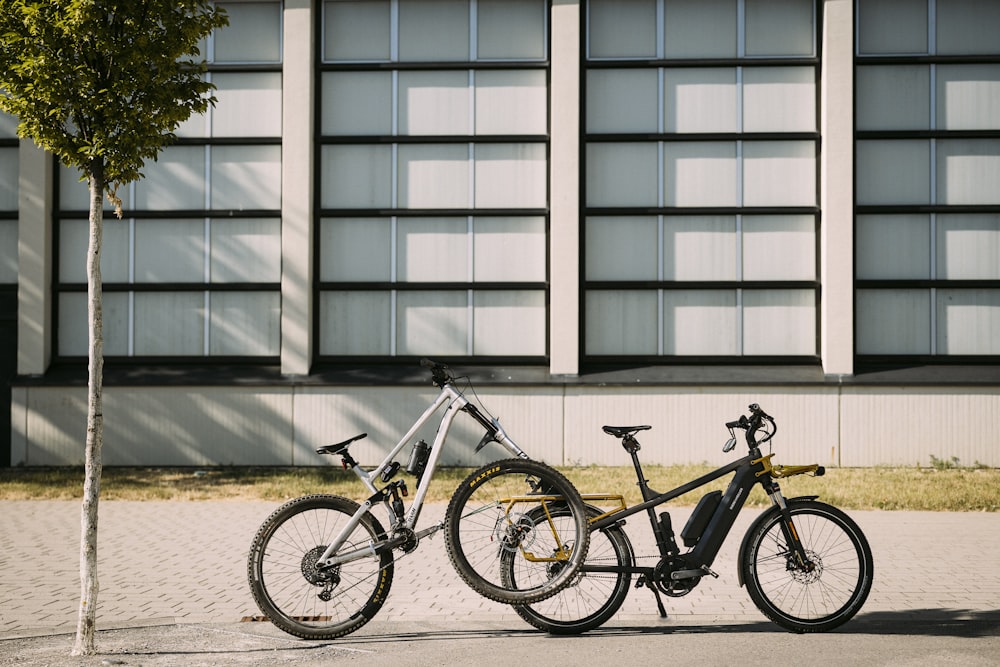 two bikes parked next to each other in front of a building