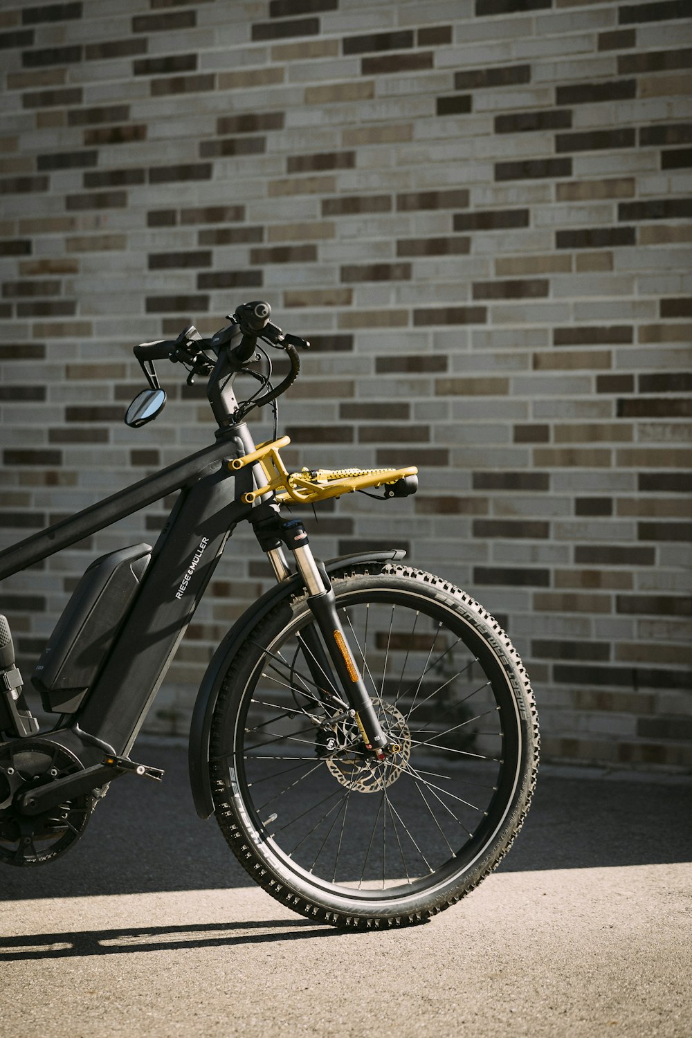 a bike parked next to a brick wall