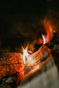 Close-up of glowing oak wood fire with bright flames.