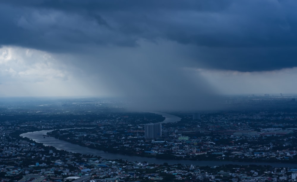 a storm moving through a city under a cloudy sky