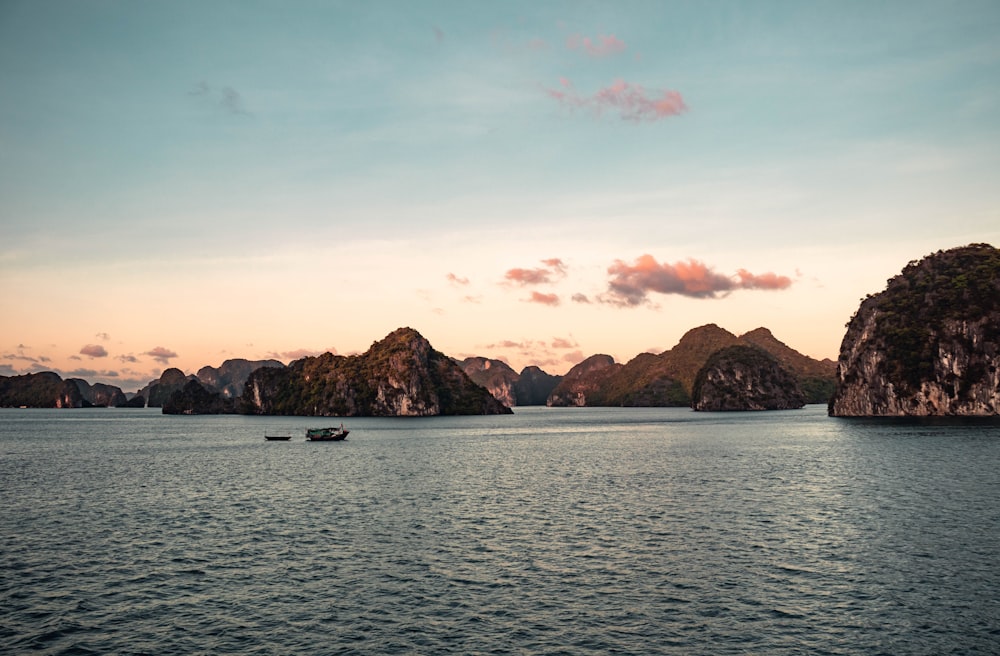 a group of small boats floating on top of a large body of water